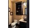 Chic powder room featuring dark wood vanity, stone countertop, and vessel sink at 1800 Amarone Way, Henderson, NV 89012