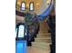 Staircase with stone stairs, ornate wrought-iron railings, and an elegant front door at 1800 Amarone Way, Henderson, NV 89012
