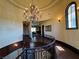An ornate wrought iron staircase sits beneath a crystal chandelier at 1800 Amarone Way, Henderson, NV 89012
