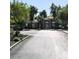 Community clubhouse and entrance to gated community with lush landscaping and paved roads at 2041 Hussium Hills St # 104, Las Vegas, NV 89108