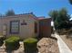 Inviting exterior of a well-maintained building with a red tile roof and desert landscaping at 2041 Hussium Hills St # 104, Las Vegas, NV 89108