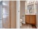 Bathroom featuring a wood vanity with an undermount sink, toilet and storage at 208 Genesee Point St, Henderson, NV 89074