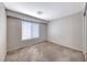 Bedroom with neutral carpeting, a bright window, and neutral paint at 208 Genesee Point St, Henderson, NV 89074