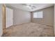 Spacious bedroom with neutral carpeting, a ceiling fan, and a bright window at 208 Genesee Point St, Henderson, NV 89074