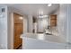 Efficient kitchen features white countertops, stainless sink, and ample storage in wood cabinets at 208 Genesee Point St, Henderson, NV 89074