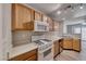 Well-equipped kitchen with white appliances, wood cabinetry, and plenty of counter space at 208 Genesee Point St, Henderson, NV 89074