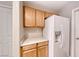 Kitchen cabinets, countertops, and a modern white refrigerator with water dispenser at 208 Genesee Point St, Henderson, NV 89074