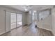 Open living space with wood floors, sliding glass door access, and an open staircase at 208 Genesee Point St, Henderson, NV 89074
