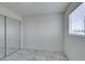 Bright bedroom featuring tile flooring, a sliding door closet and a window at 212 Orland St # 28, Las Vegas, NV 89107
