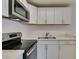 Modern kitchen features stainless steel appliances, white cabinetry and bright lighting at 212 Orland St # 28, Las Vegas, NV 89107