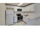 Well-lit kitchen featuring stainless steel appliances, white cabinets, and modern countertops at 212 Orland St # 28, Las Vegas, NV 89107