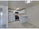 Open kitchen space features white cabinets, stainless steel appliances, and modern flooring at 212 Orland St # 28, Las Vegas, NV 89107