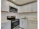 Bright kitchen features stainless steel microwave and range and ample countertop space at 212 Orland St # 28, Las Vegas, NV 89107