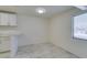 Inviting living space features neutral colors, a large window, and tile floors, leading to an open kitchen at 212 Orland St # 28, Las Vegas, NV 89107