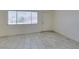 Bright living room featuring tile flooring, a window and a front door at 212 Orland St # 28, Las Vegas, NV 89107