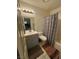 Well-lit bathroom with a gray vanity, modern fixtures, and a patterned shower curtain at 2136 Bavington Dr # A, Las Vegas, NV 89108