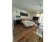 Cozy bedroom features hardwood floors, minimalist decor, and a bright, airy ambiance with natural light at 2136 Bavington Dr # A, Las Vegas, NV 89108