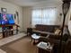 Inviting living room featuring a comfortable brown sectional sofa and large window at 2136 Bavington Dr # A, Las Vegas, NV 89108