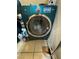 Modern blue front-load washing machine with stainless steel trim and digital display at 2136 Bavington Dr # A, Las Vegas, NV 89108