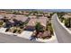 Wide aerial shot displaying a home's landscaping, nearby neighborhood, and scenic mountain backdrop at 2221 River Grove Dr, Henderson, NV 89044