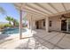 Spacious covered patio with ceiling fans, overlooking the pool area and lush landscaping at 2221 River Grove Dr, Henderson, NV 89044