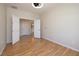 Large bedroom featuring a ceiling fan, light hardwood flooring, and a double door entry at 2221 River Grove Dr, Henderson, NV 89044
