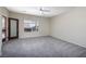 Bedroom featuring gray carpet, light walls, a ceiling fan and access to an outdoor space at 2221 River Grove Dr, Henderson, NV 89044