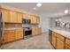 Traditional kitchen featuring stainless steel appliances, light wood cabinets and tile backsplash at 2221 River Grove Dr, Henderson, NV 89044