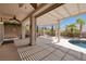 Inviting covered patio with ample space and ceiling fan overlooks the refreshing private swimming pool area at 2221 River Grove Dr, Henderson, NV 89044
