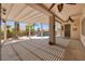Relaxing covered patio area with open beams, ceiling fan, and pool access, perfect for outdoor entertaining at 2221 River Grove Dr, Henderson, NV 89044