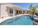 Gorgeous pool with adjacent covered patio offers a perfect oasis for relaxation and entertainment at 2221 River Grove Dr, Henderson, NV 89044