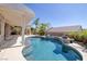 Sparkling pool with a spa and covered patio, complemented by lush landscaping for a tranquil retreat at 2221 River Grove Dr, Henderson, NV 89044
