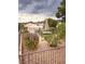 Fenced backyard oasis featuring patio table with umbrella and low-maintenance rock landscaping at 2504 Libretto Ave, Henderson, NV 89052