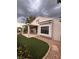 Inviting backyard featuring a covered patio, artificial turf, and decorative rock landscaping for easy maintenance at 2504 Libretto Ave, Henderson, NV 89052