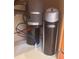 Under-sink view of home water filtration and softening system at 2504 Libretto Ave, Henderson, NV 89052