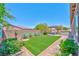 Lush backyard featuring a pergola seating area, built-in grill, and well-manicured artificial turf at 280 Via Del Duomo, Henderson, NV 89011