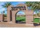 Entrance to Chimera Golf Club framed by an adobe archway, with palm trees and mountain views at 280 Via Del Duomo, Henderson, NV 89011