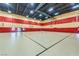 A well lit gymnasium with basketball hoops and a clean, spacious floor at 280 Via Del Duomo, Henderson, NV 89011
