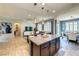Stylish kitchen island with granite countertop, pendant lighting, flowing to living and dining spaces at 280 Via Del Duomo, Henderson, NV 89011
