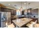 Modern kitchen with stainless steel appliances, granite counters, tiled backsplash, and island seating at 280 Via Del Duomo, Henderson, NV 89011