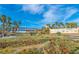 Scenic view of Lake Las Vegas featuring a bridge, palm trees, and community signage at 280 Via Del Duomo, Henderson, NV 89011