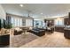Bright living space featuring a large sectional sofa, tile flooring, and an open layout into the kitchen at 280 Via Del Duomo, Henderson, NV 89011