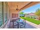 Relaxing covered patio with outdoor seating, fan, and a well-maintained artificial lawn at 280 Via Del Duomo, Henderson, NV 89011