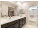 Bathroom featuring dual sinks, large vanity mirror, and a convenient glass-enclosed shower at 2860 Sunflower Days Ave # 2141, North Las Vegas, NV 89031