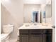 This bathroom features a large vanity, a neutral color palette and a white ceramic toilet at 2860 Sunflower Days Ave # 2141, North Las Vegas, NV 89031