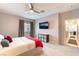 Serene bedroom with mounted TV, soft carpet, and a glimpse into the adjacent living spaces at 2860 Sunflower Days Ave # 2141, North Las Vegas, NV 89031
