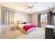 Relaxing bedroom with neutral tones, ceiling fan, and a cozy bed with colorful accents at 2860 Sunflower Days Ave # 2141, North Las Vegas, NV 89031