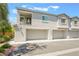 A well-maintained two-story townhome with a private balcony and two-car garage under a blue sky at 2860 Sunflower Days Ave # 2141, North Las Vegas, NV 89031