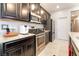 Modern kitchen with stainless steel oven and microwave, granite countertops, and sleek dark cabinetry at 2860 Sunflower Days Ave # 2141, North Las Vegas, NV 89031