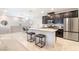 Bright kitchen features granite counters, stainless steel appliances, and an island with bar stools at 2860 Sunflower Days Ave # 2141, North Las Vegas, NV 89031